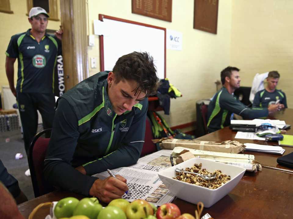 Pat Cummins solves a crossword during the rain break, Australia v India, Carlton Mid Tri-Series, Sydney, January 26, 2015