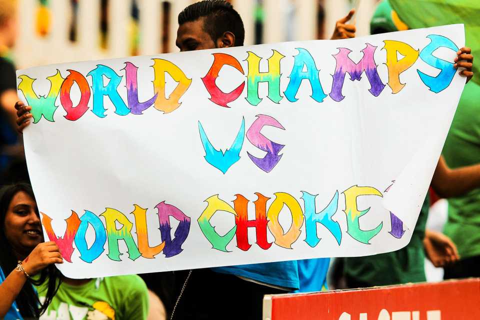Fans hold up a poster mocking South Africa's malaise in big tournaments