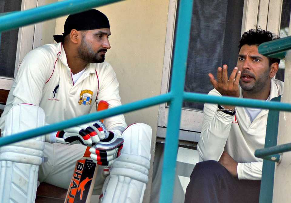Harbhajan Singh and Yuvraj Singh chat during the Ranji Trophy match against Delhi