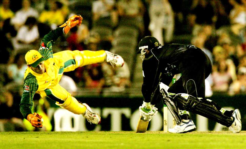 Adam Gilchrist dives for a catch