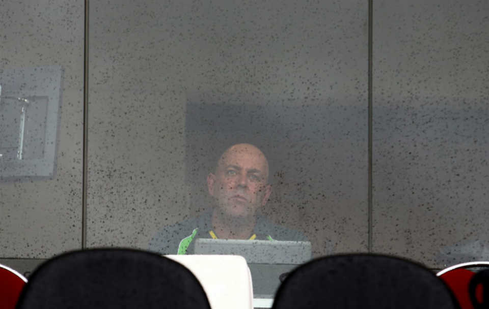 Darren Lehmann watches from the dressing room as the rain shows no signs of stopping