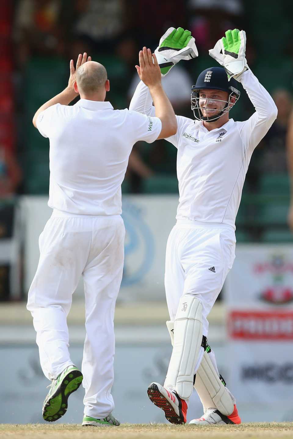 James Tredwell gets a high five from Jos Buttler