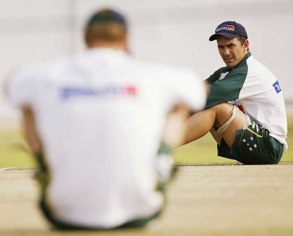 Matthew Hayden concentrates on the pitch as Justin Langer looks on