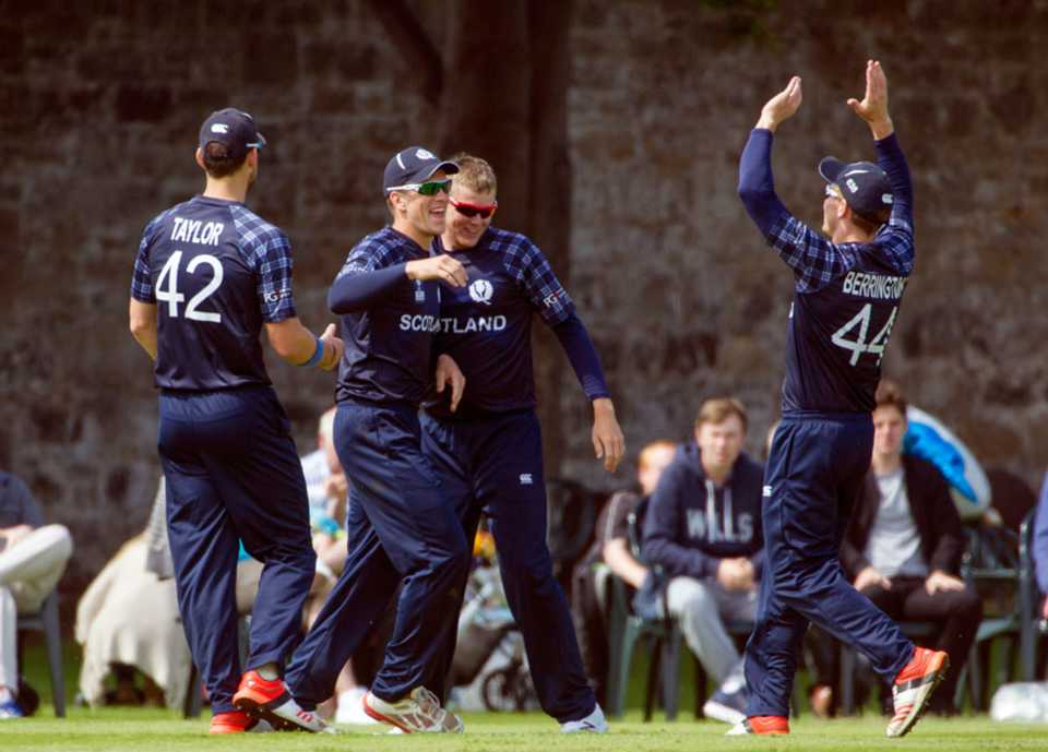 The Scotland players celebrate a wicket 