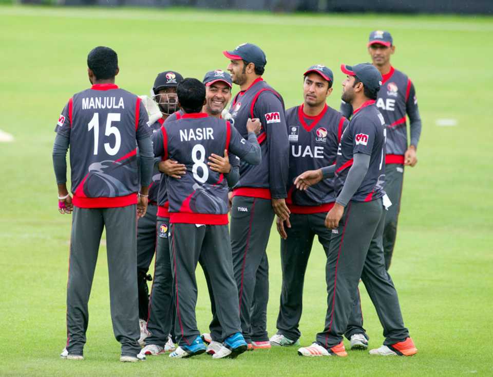 The UAE players get together after a wicket