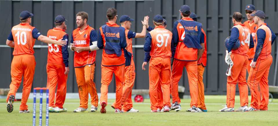 Netherlands players get together after a wicket