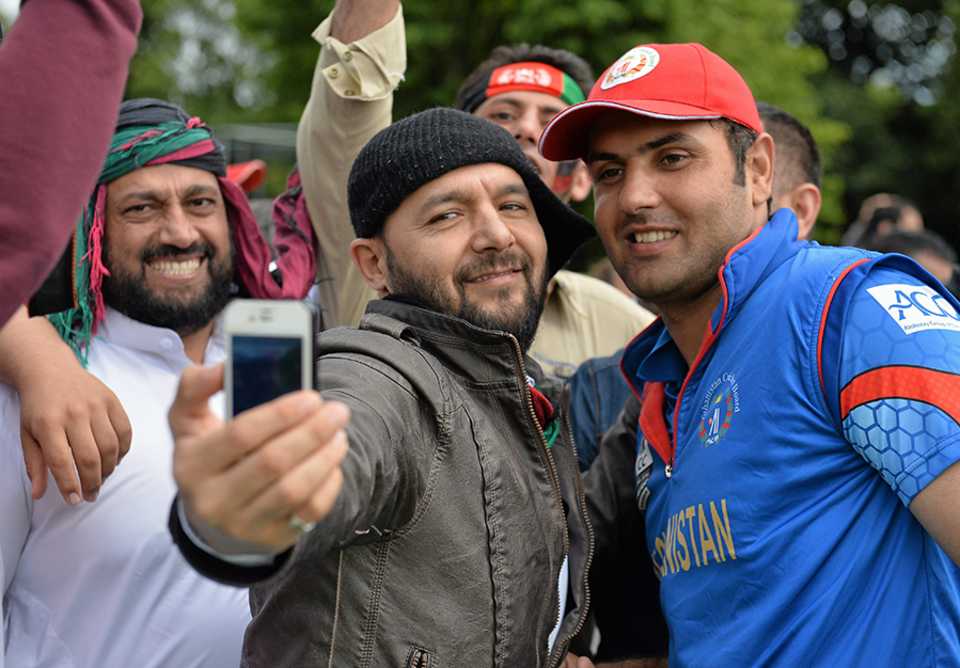The celebratory selfie: Mohammad Nabi poses for a selfie with a fan