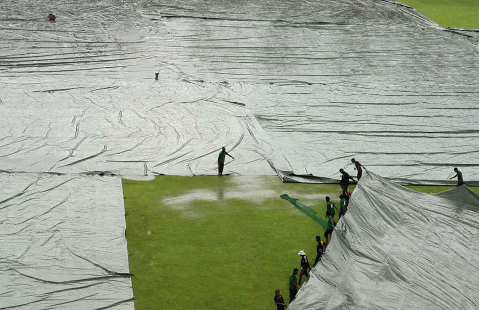The ground staff bring on additional covers, Bangladesh v South Africa, 2nd Test, Mirpur, 4th day, August 2, 2015