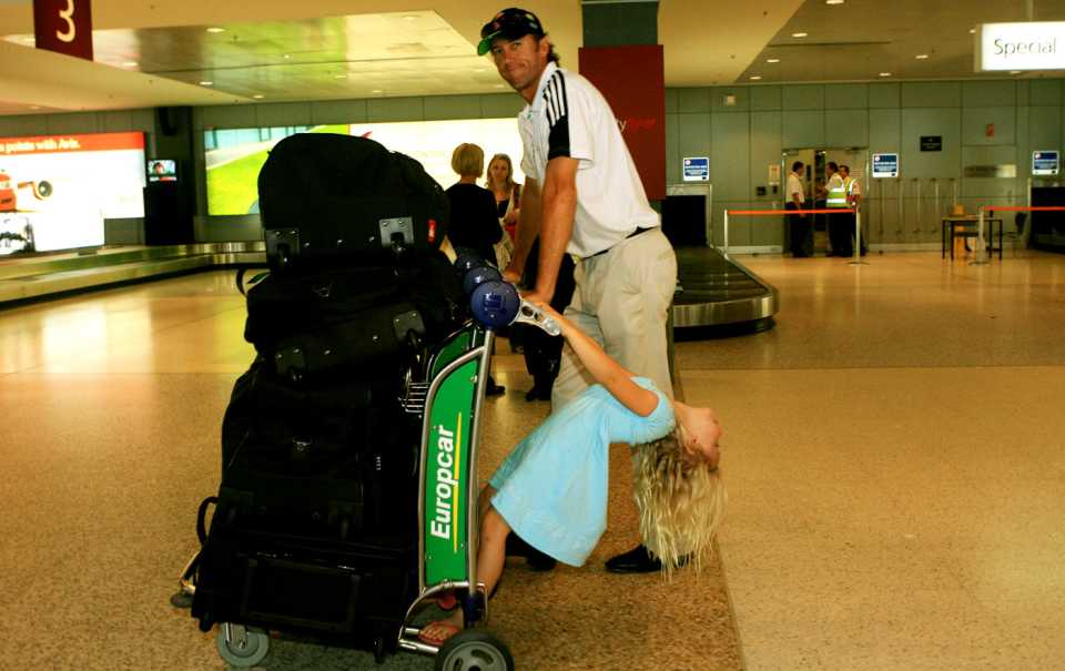 Glenn McGrath gets help with the luggage from his daughter Holly
