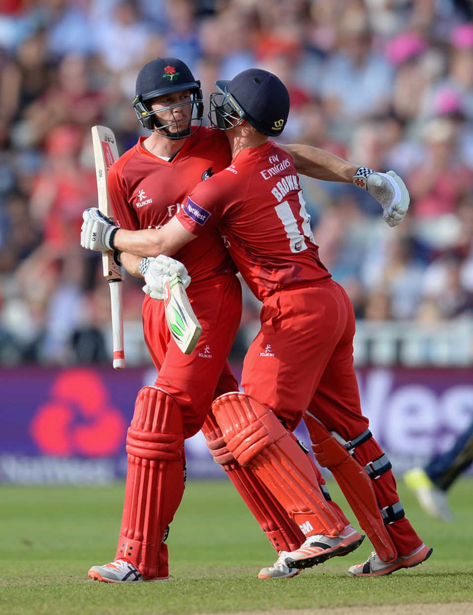 James Faulkner celebrates with Karl Brown after the Australian thumped two sixes to seal Lancashire's place in the final