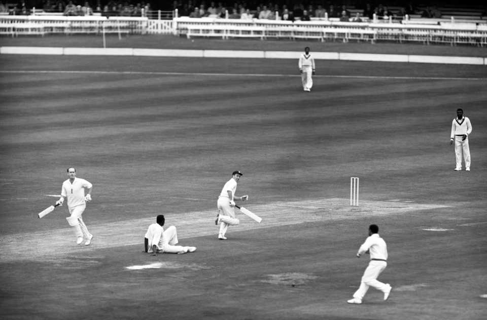 Brian Close and Fred Titmus take a single and bowler Wes Hall sits on the ground