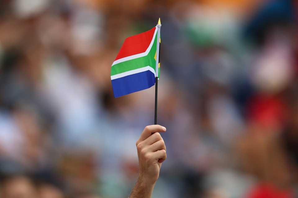 A fan holds the South African flag aloft