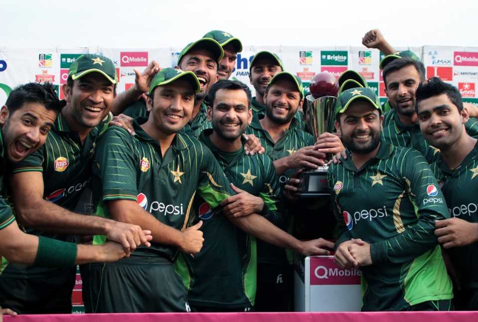 The Pakistan players pose with the trophy