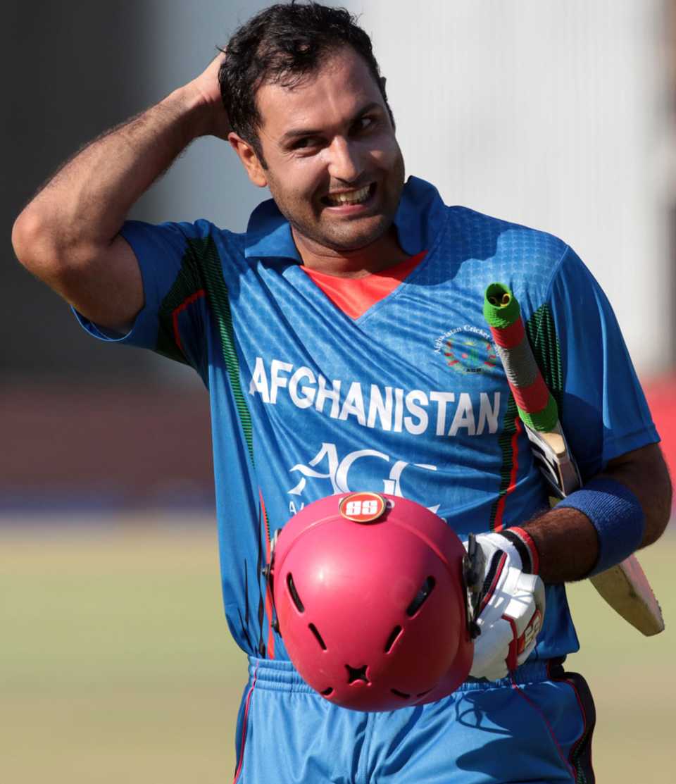 A smiling Mohammad Nabi walks back after steering Afghanistan to victory
