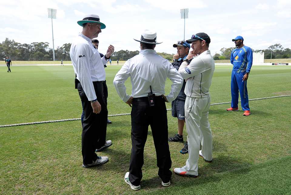 Brendon McCullum and New Zealand coach Mike Hesson talk to match officials