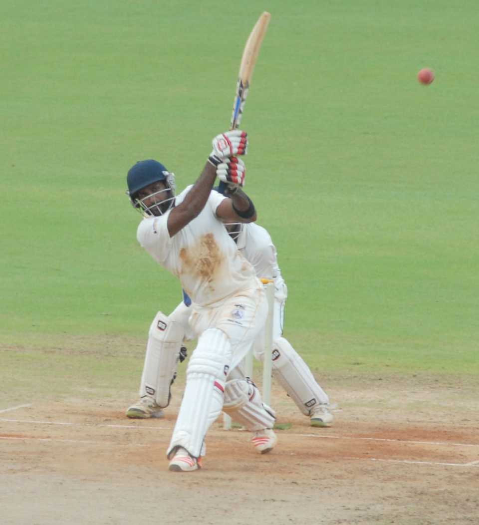 R Sathish launches one down the ground during his 33