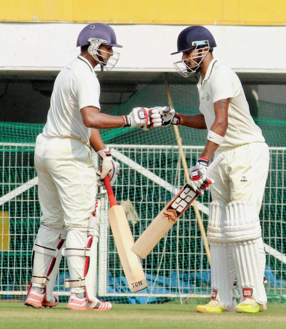 Ganesh Satish and S Badrinath punch gloves during their 127-run stand