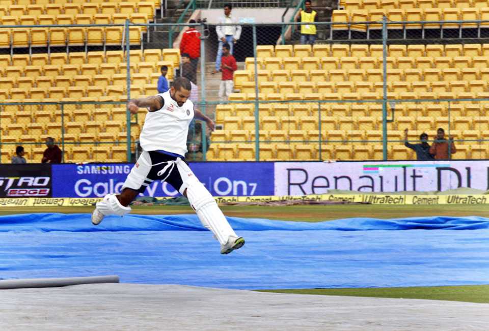 Shikhar Dhawan leaps over the covers on a rainy day, India v South Africa, 2nd Test, Bangalore, 5th day, November 18, 2015