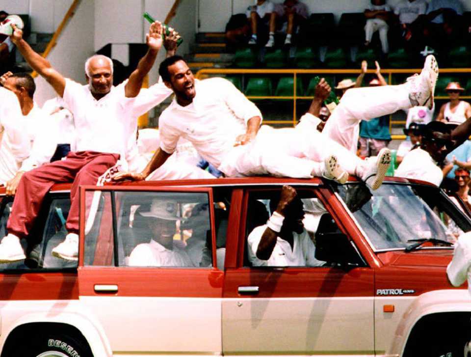 The West Indies team ride in a four-wheel-drive vehicle driven by Man of the Series Curtly Ambrose