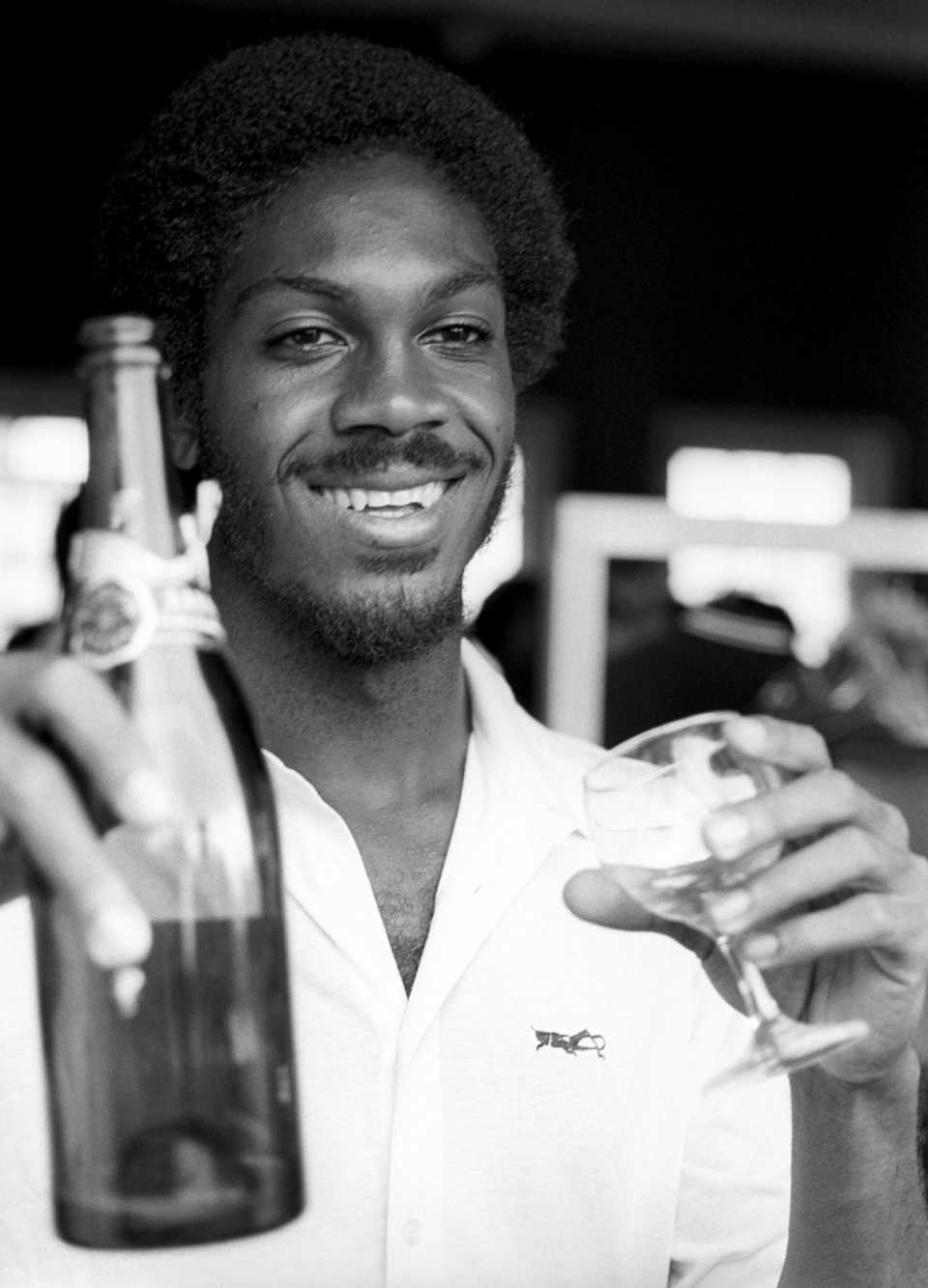 Michael Holding enjoys some champagne after his 14 wickets