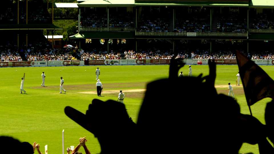 The crowd cheers as Damien Martyn reaches his half-century