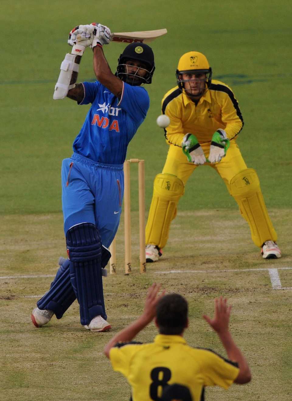 Shikhar Dhawan goes down the ground during his 74