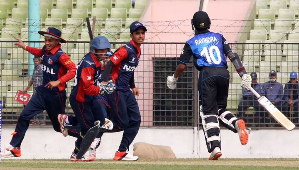 Nepal Under-19 players celebrate the run-out of New Zealand Under-19 opener Rachin Ravindra