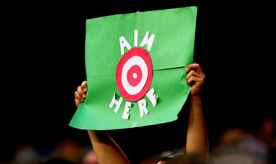 A fan holds up a sign reading: "Aim here"