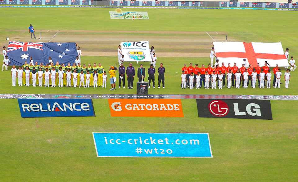 The England and Australia teams line up for the national anthems