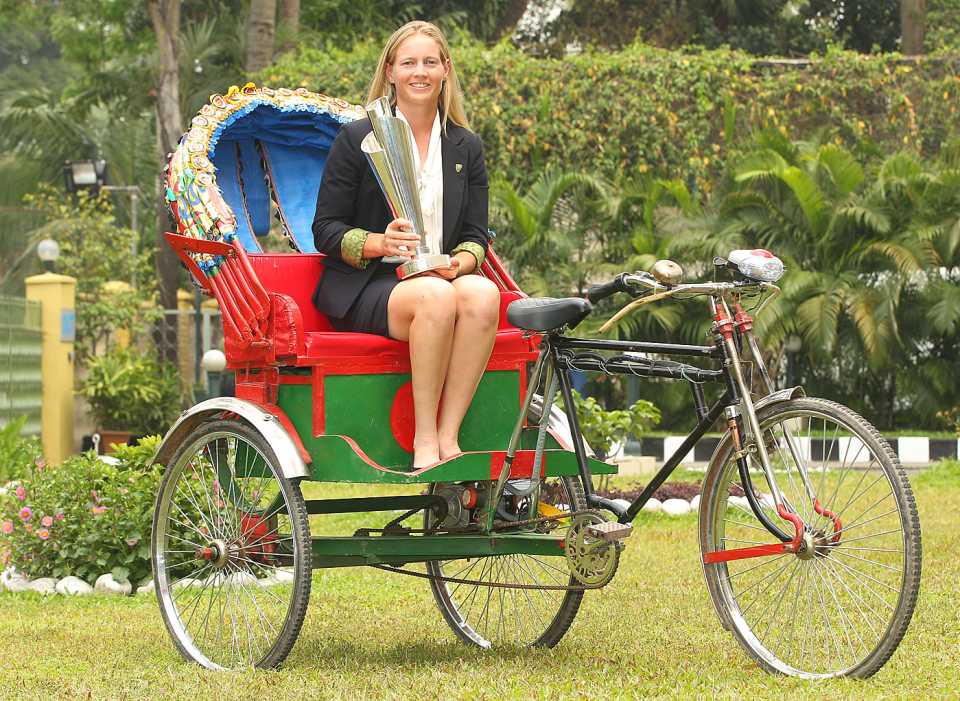 Meg Lanning poses with the World T20 trophy seated in a rickshaw