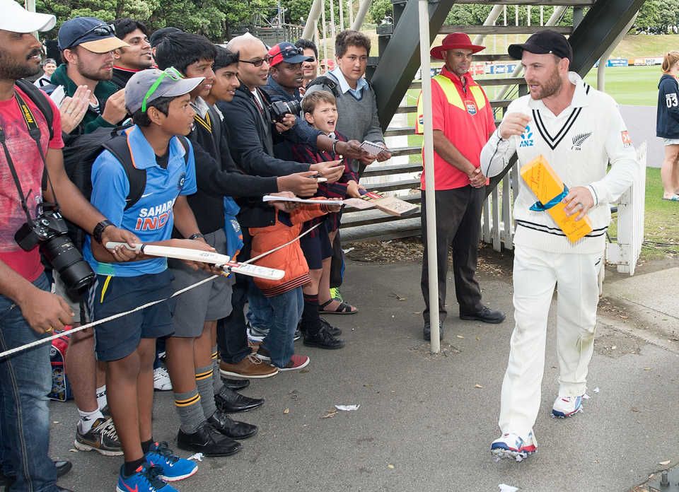 Brendon McCullum walks past a group of fans