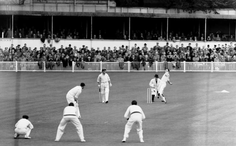 Fast bowler Pat Crawford bowls. Len Maddocks is the keeper