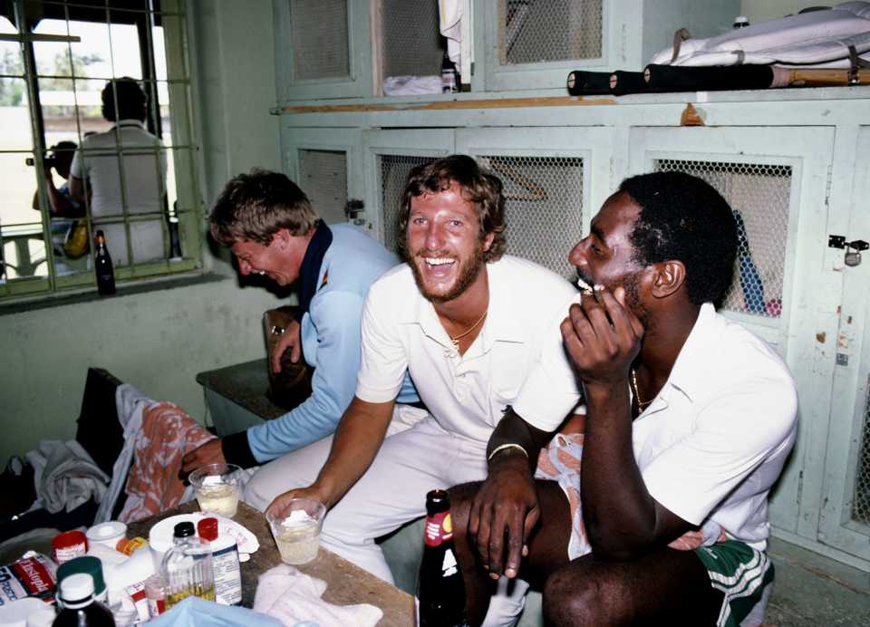 Ian Botham and Viv Richards enjoy a drink or two in the dressing room after the Test