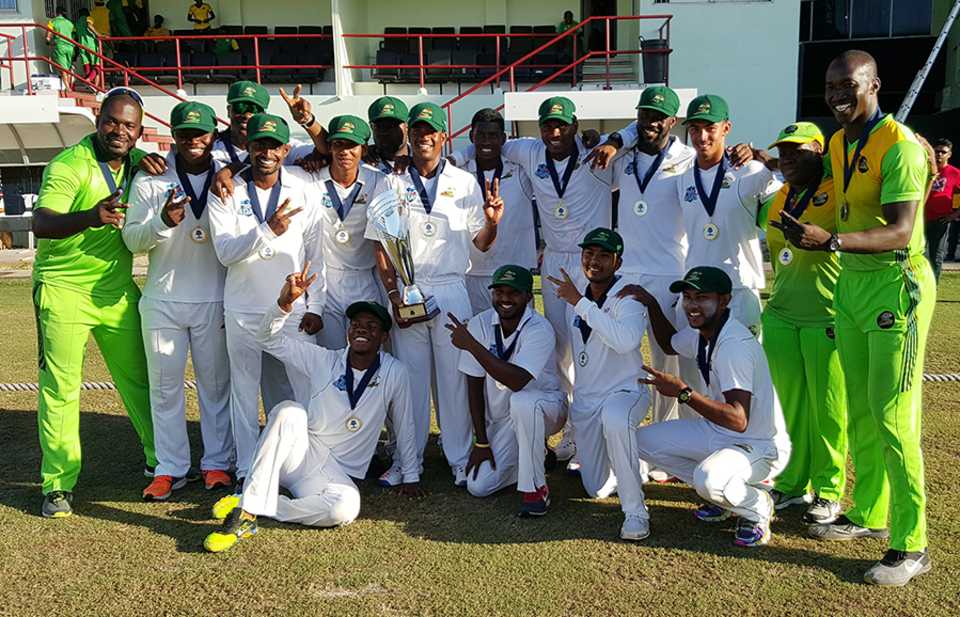 The jubilant Guyana team pose with the Regional 4-day Tournament trophy