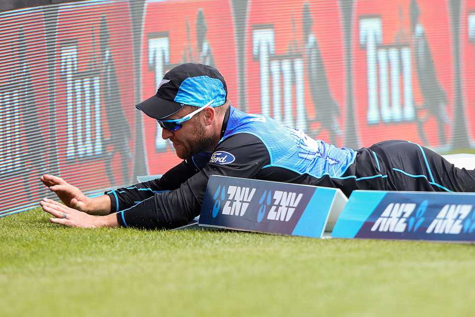 Brendon McCullum slides past the rope and nearly collides with the advertising board
