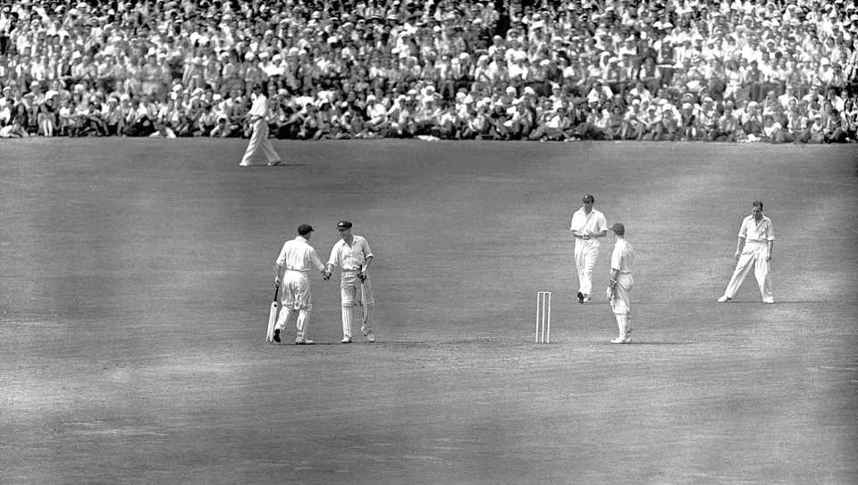 Arthur Morris is congratulated by Don Bradman on reaching his century