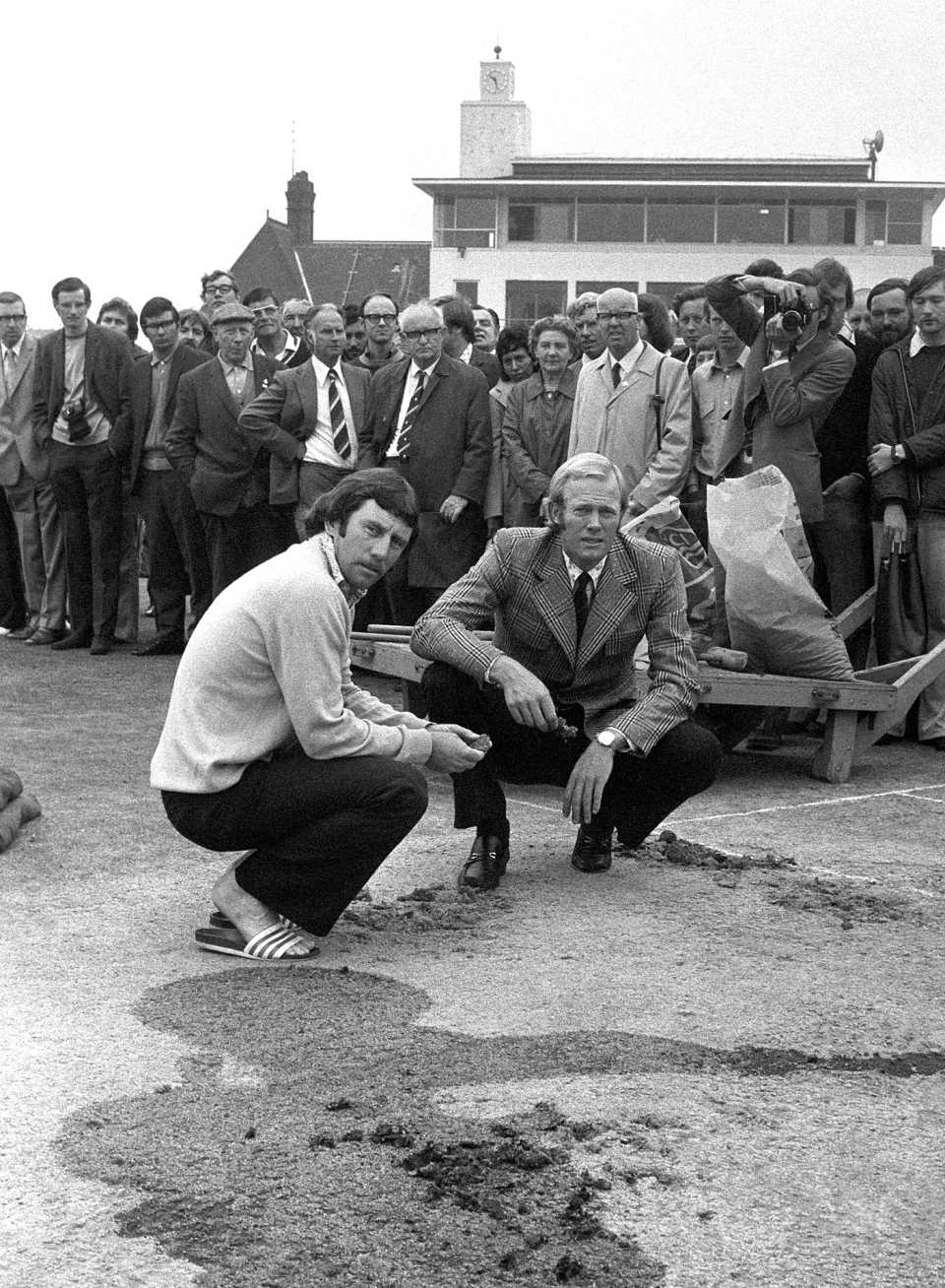 Tony Greig and Ian Chappell inspect the vandalised pitch