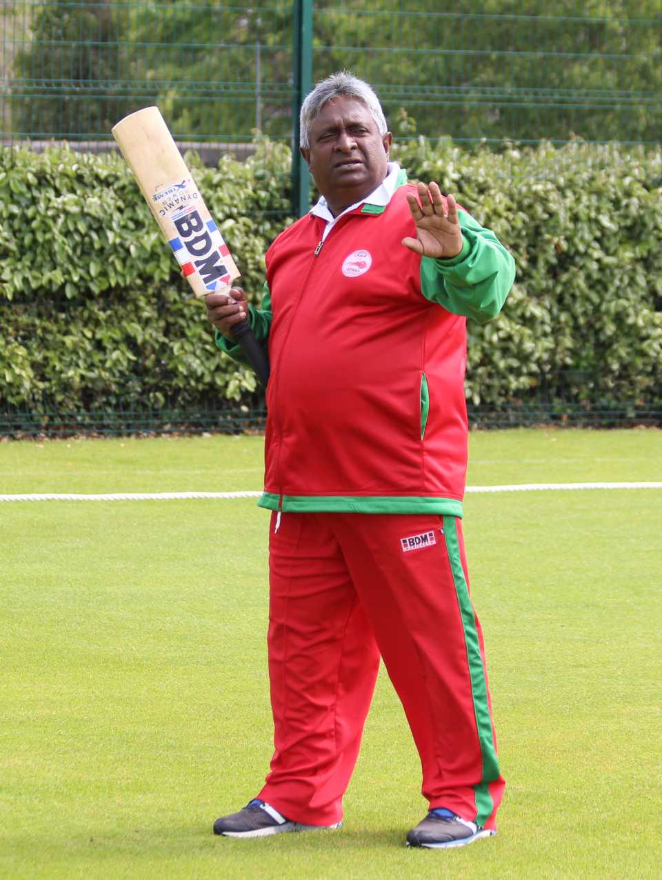 Oman coach Duleep Mendis goes through some instructions during warm-ups