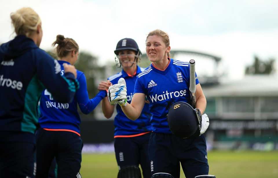 Heather Knight and Natalie Sciver celebrate England's win with team-mates