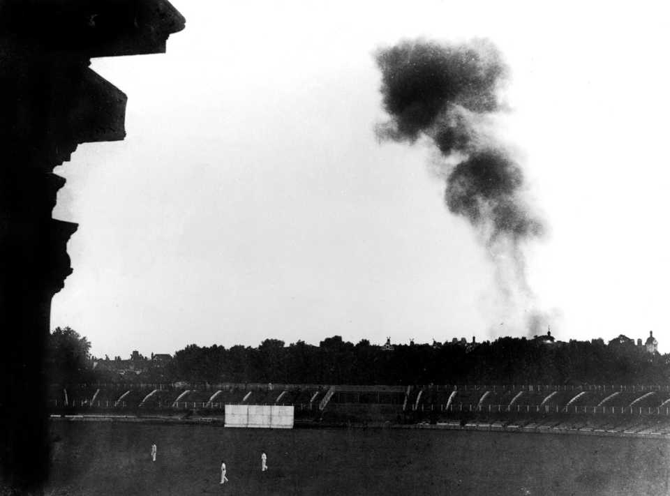 Smoke from a V-1 flying bomb rises above Lord's during a wartime match