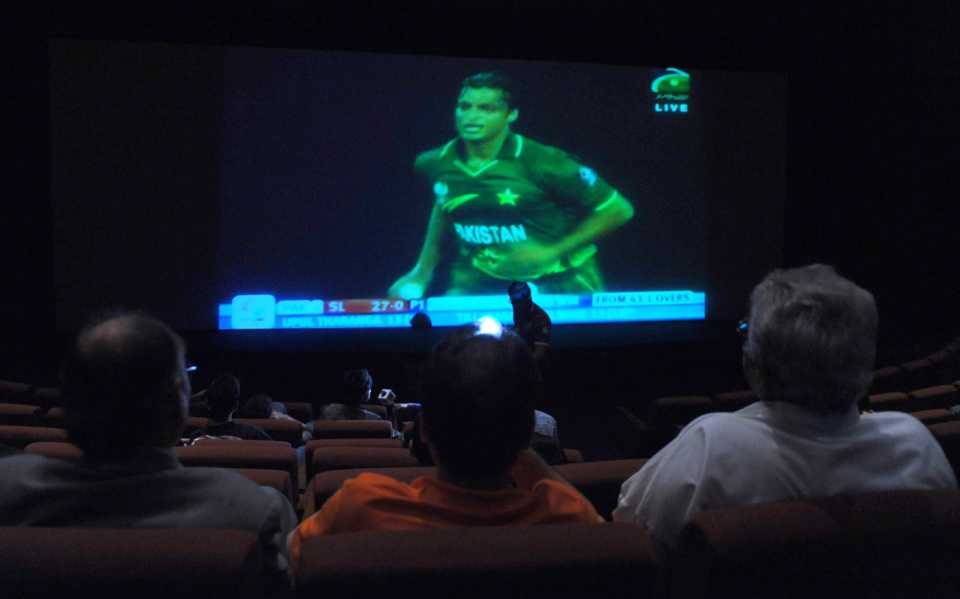 Fans watch the match on a big screen in Karachi
