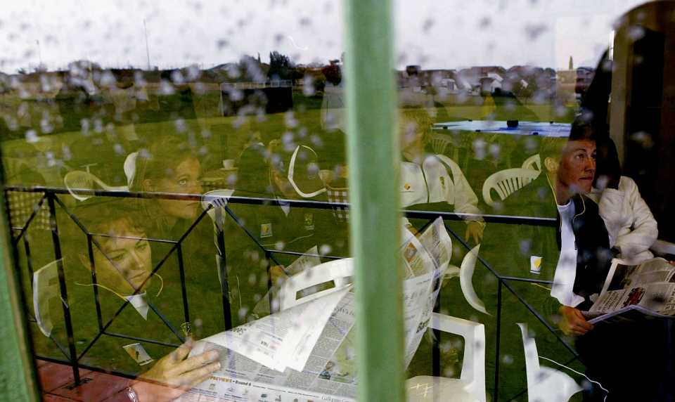 Karen Rolton and other Australian players wait inside during a rain interruption