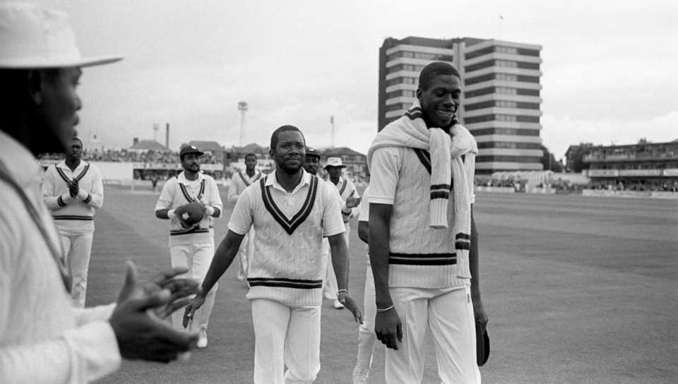 Curtly Ambrose and Malcolm Marshall walk back after sharing ten wickets between them in England's first inning