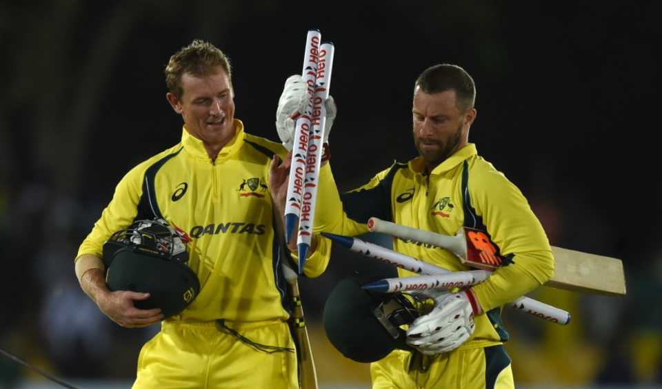 Matthew Wade and George Bailey collect souvenirs after Australia's win