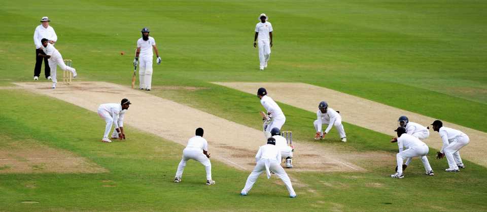 Rangana Herath bowls with a packed close-in field