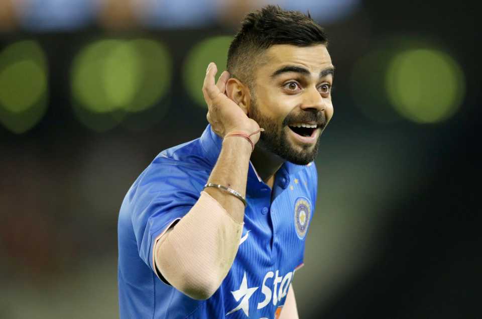 Virat Kohli puts his hand to his ear as the crowd heckles him