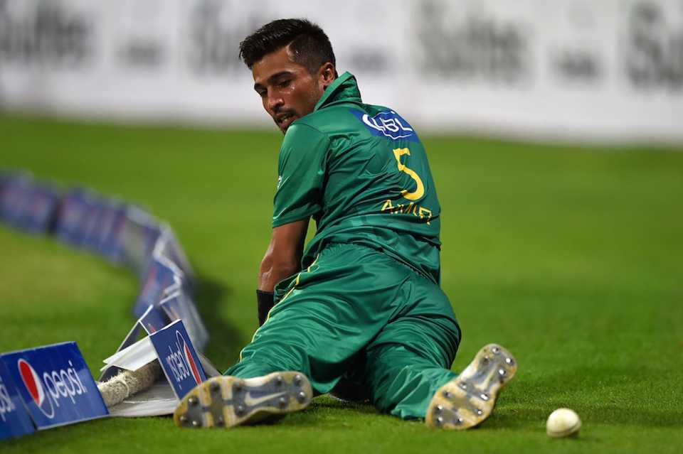 Mohammad Amir looks back after he could not stop the ball