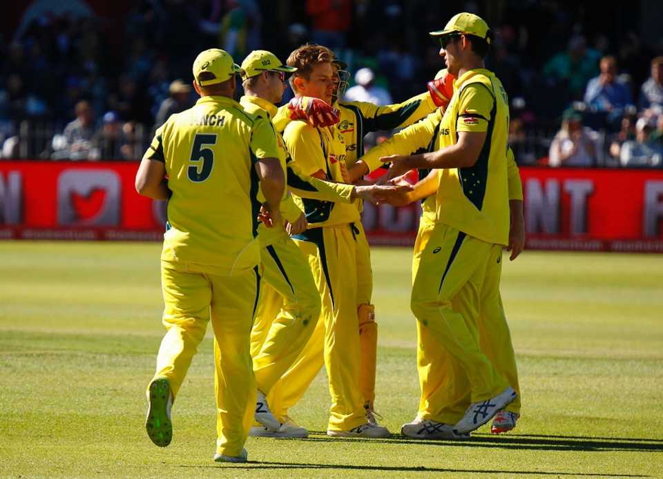 Adam Zampa is mobbed by his team-mates