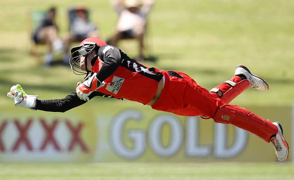 Alex Carey takes an acrobatic catch behind the stumps in the Matador Cup