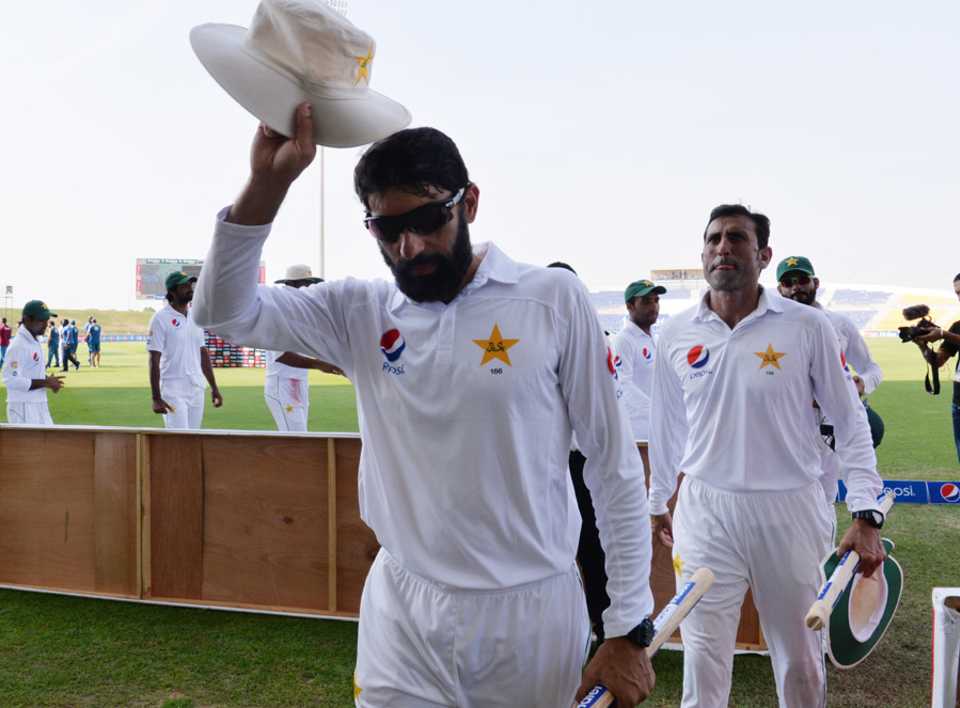 Misbah-ul-Haq leads his team off after clinching the series